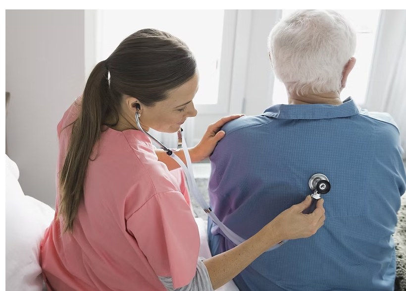 Clinician using a stethoscope with a patient
